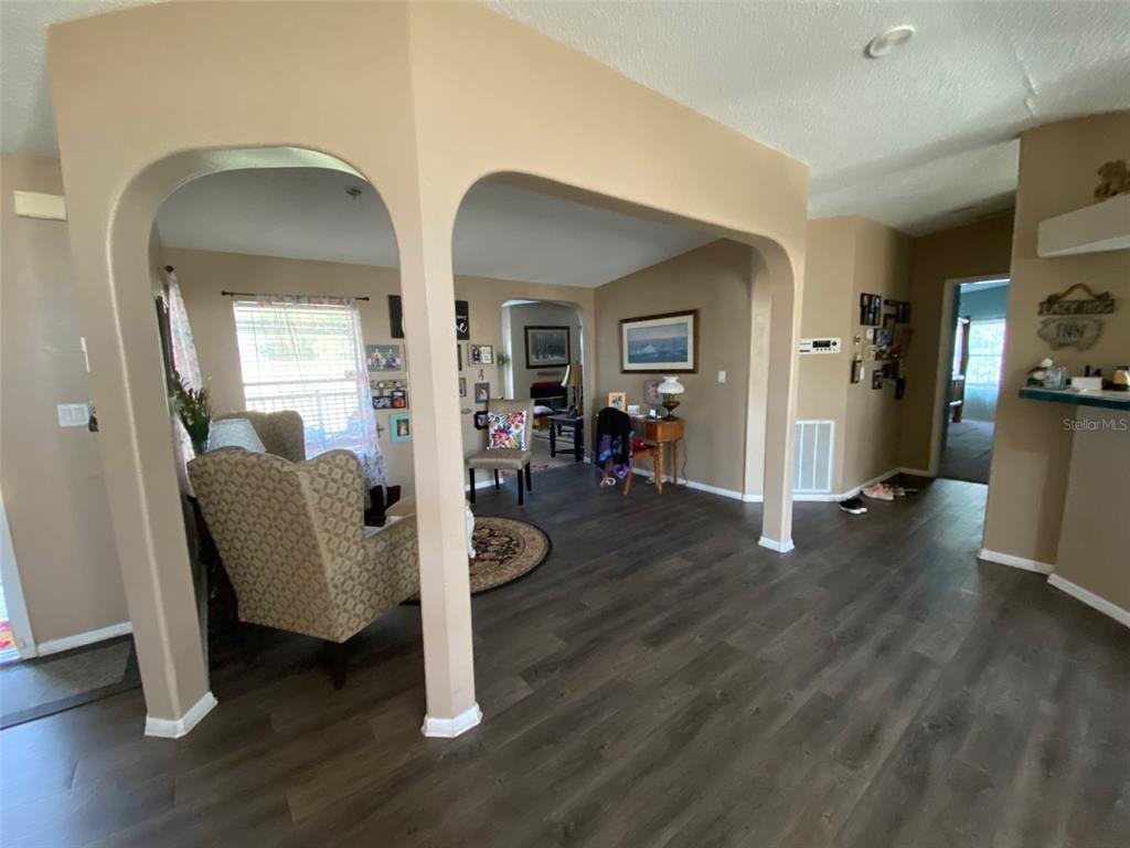 31244 Tyndall Road Zephyrhills, FL 33545 - Photo 3 of 24 a living room with furniture and a wooden floor