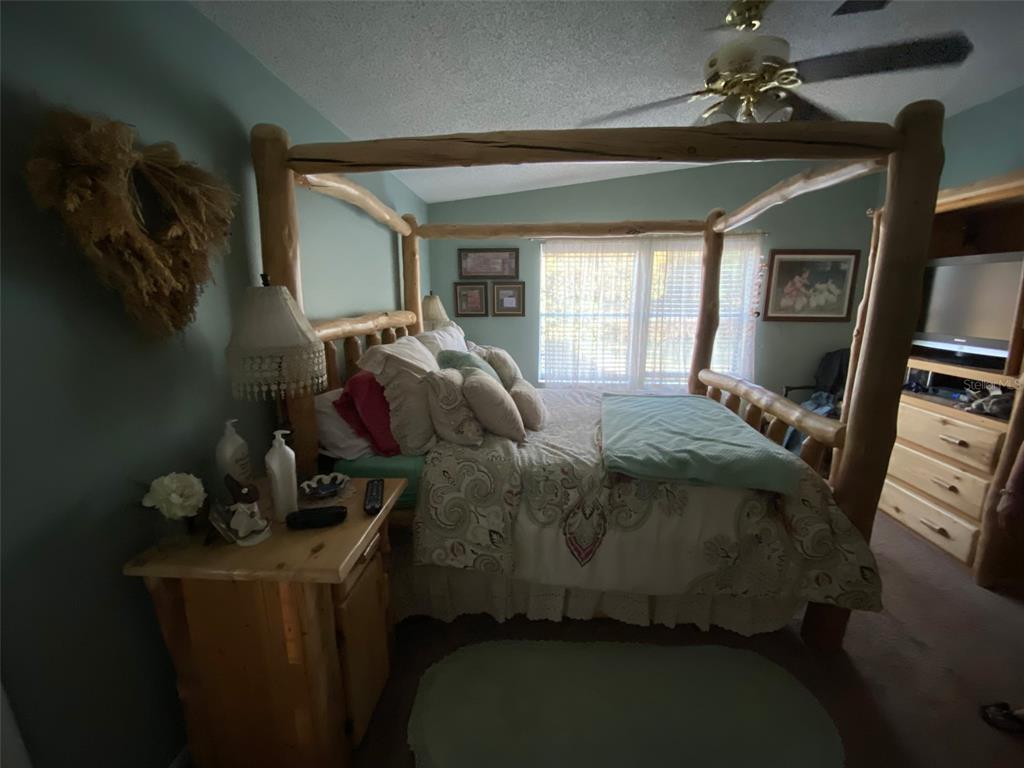 31244 Tyndall Road Zephyrhills, FL 33545 - Photo 7 of 24 a bedroom with a bed and a window