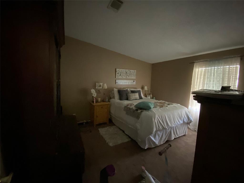 31244 Tyndall Road Zephyrhills, FL 33545 - Photo 8 of 24 a bedroom with a bed and a window