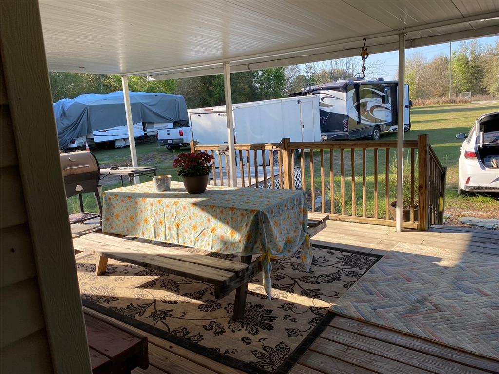 31244 Tyndall Road Zephyrhills, FL 33545 - Photo 10 of 24 a view of a patio with a table and chairs