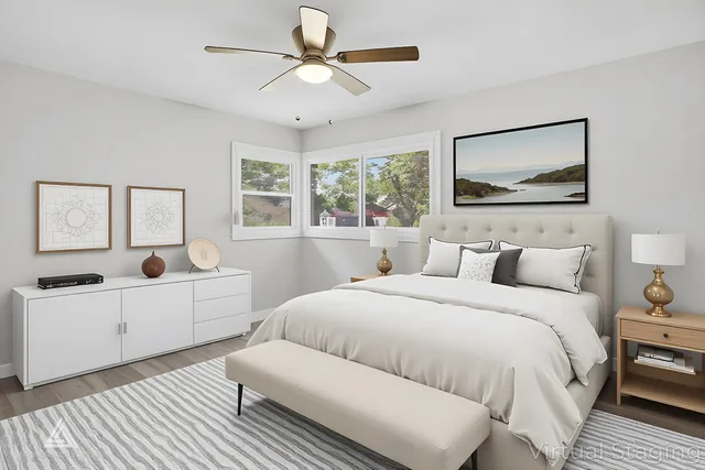 a bedroom with a large bed and a chandelier