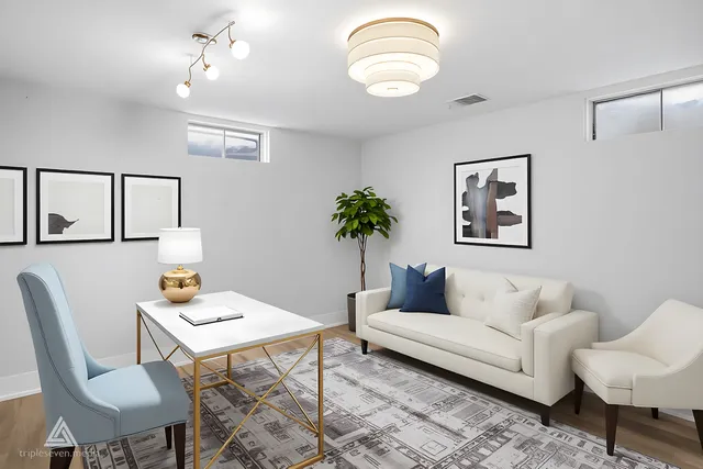 a living room with furniture and a potted plant
