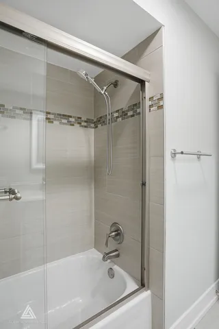 a bathroom with a tub and shower