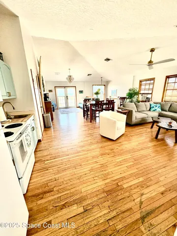 a view of a bedroom with wooden floor and a bed