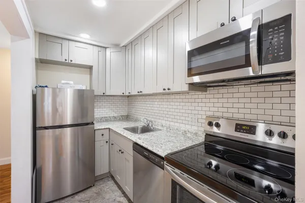 a kitchen with a refrigerator stove and microwave