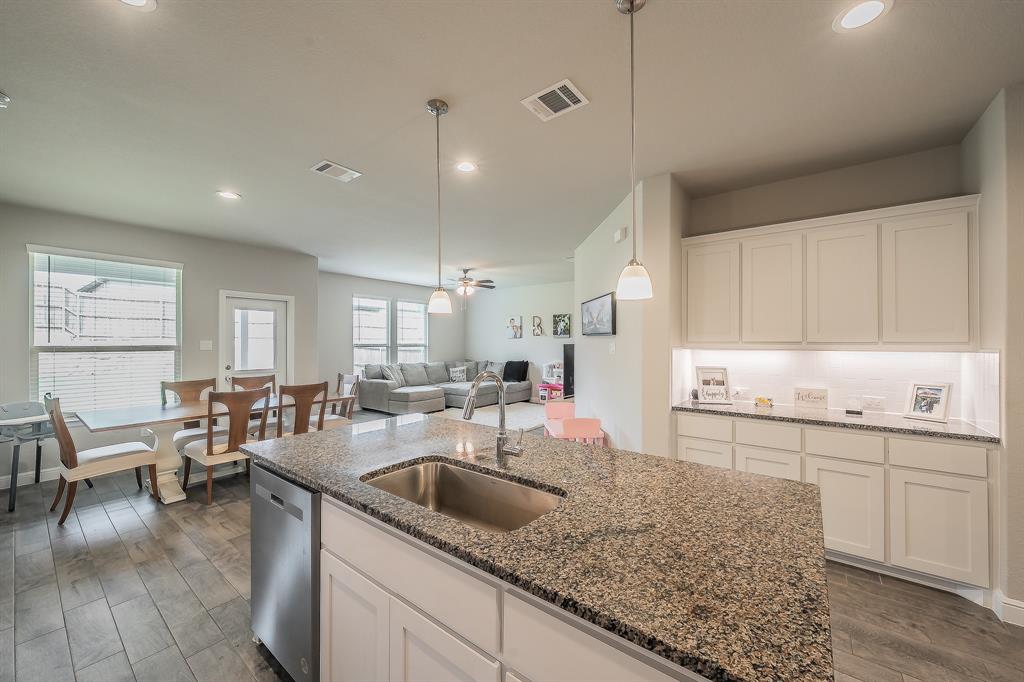 1212 Bosque Lane Weatherford, TX 76087 - Photo 8 of 38 a kitchen with counter top space sink stove and cabinets
