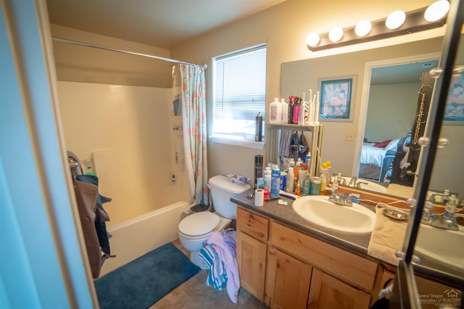 63287 Vogt Road Bend, OR 97701 - Photo 7 of 16 a bathroom with a sink vanity mirror and toilet