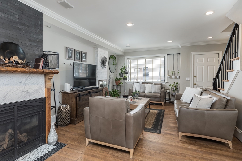 571 East 3rd Street Boston, MA 02127 - Photo 1 of 20 a living room with furniture and a fireplace