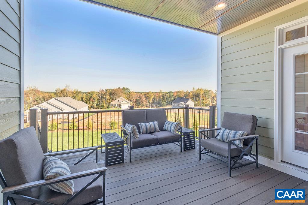 189 Timber Ridge Lane Zion Crossroads, VA 22942 - Photo 29 of 40 a balcony with furniture and wooden floor