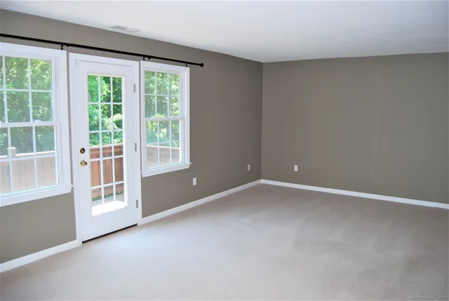 a view of a house with a yard and potted plants