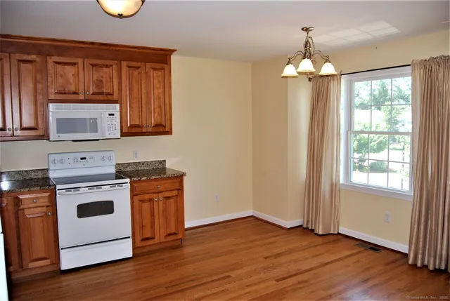 a kitchen with a stove oven and a microwave