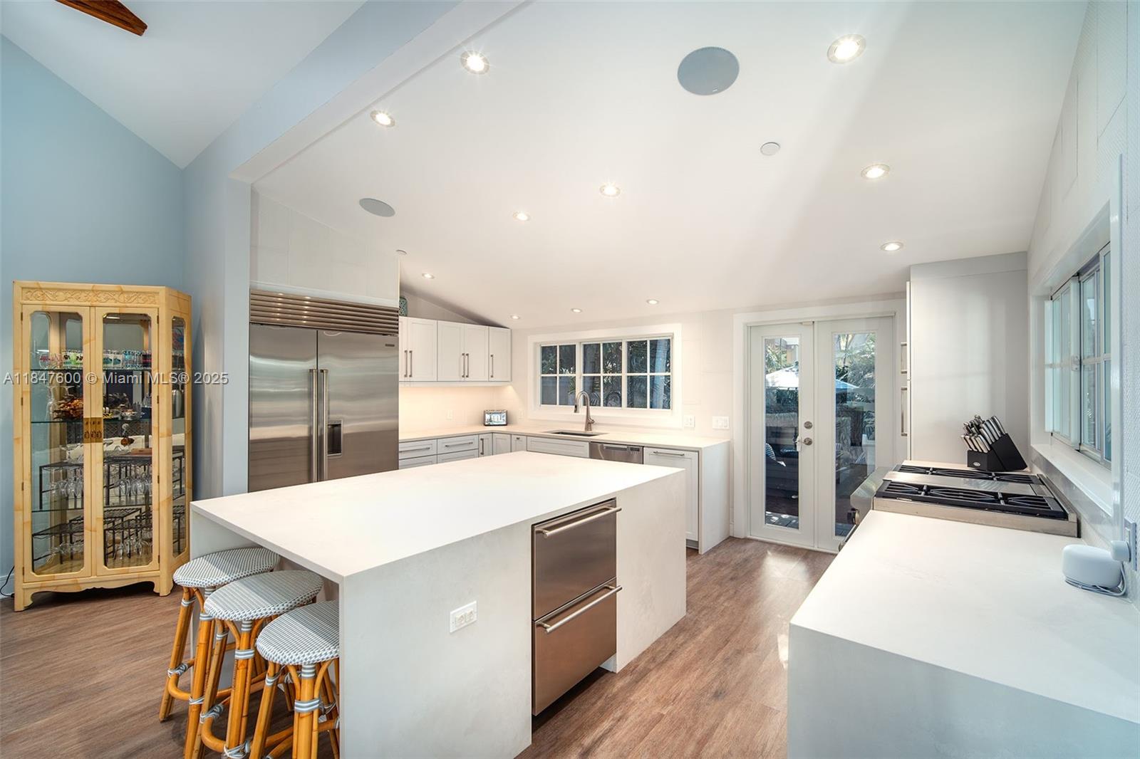 1114 Packer Street Key West, FL 33040 - Photo 41 of 98 a large kitchen with stainless steel appliances a large counter top and a stove