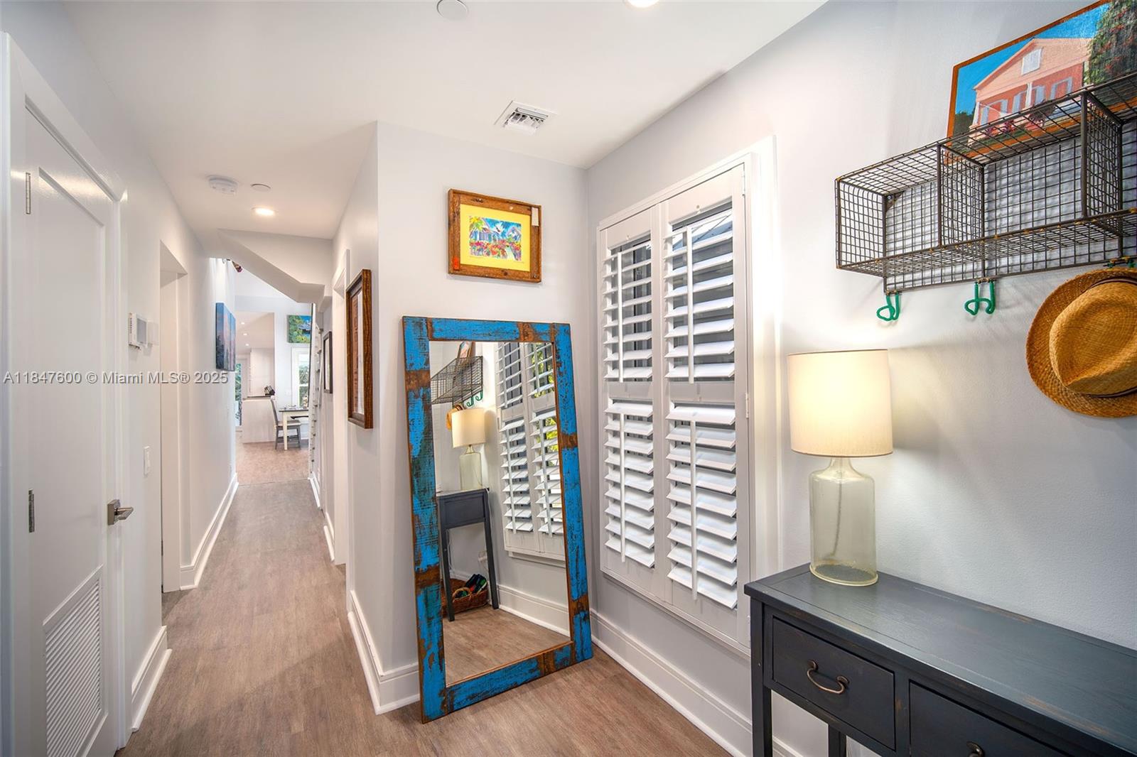 1114 Packer Street Key West, FL 33040 - Photo 79 of 98 a hallway with painting on the wall and a potted plant