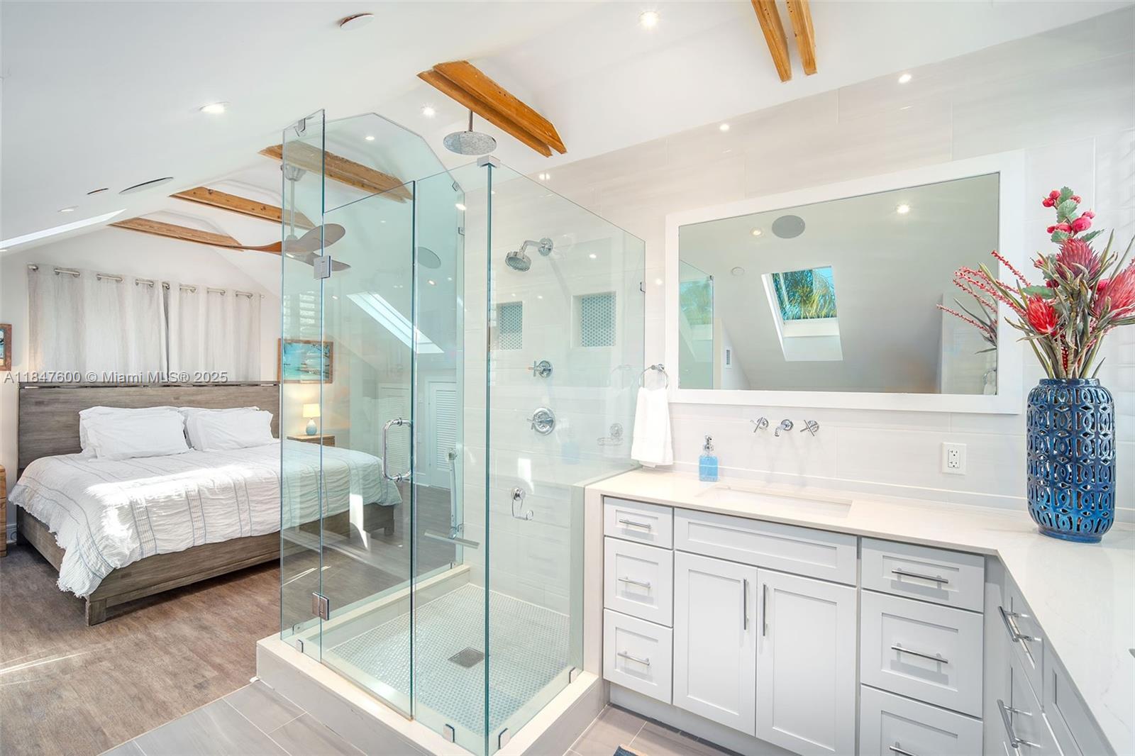 1114 Packer Street Key West, FL 33040 - Photo 96 of 98 a spacious bathroom with a double vanity sink a mirror and a shower