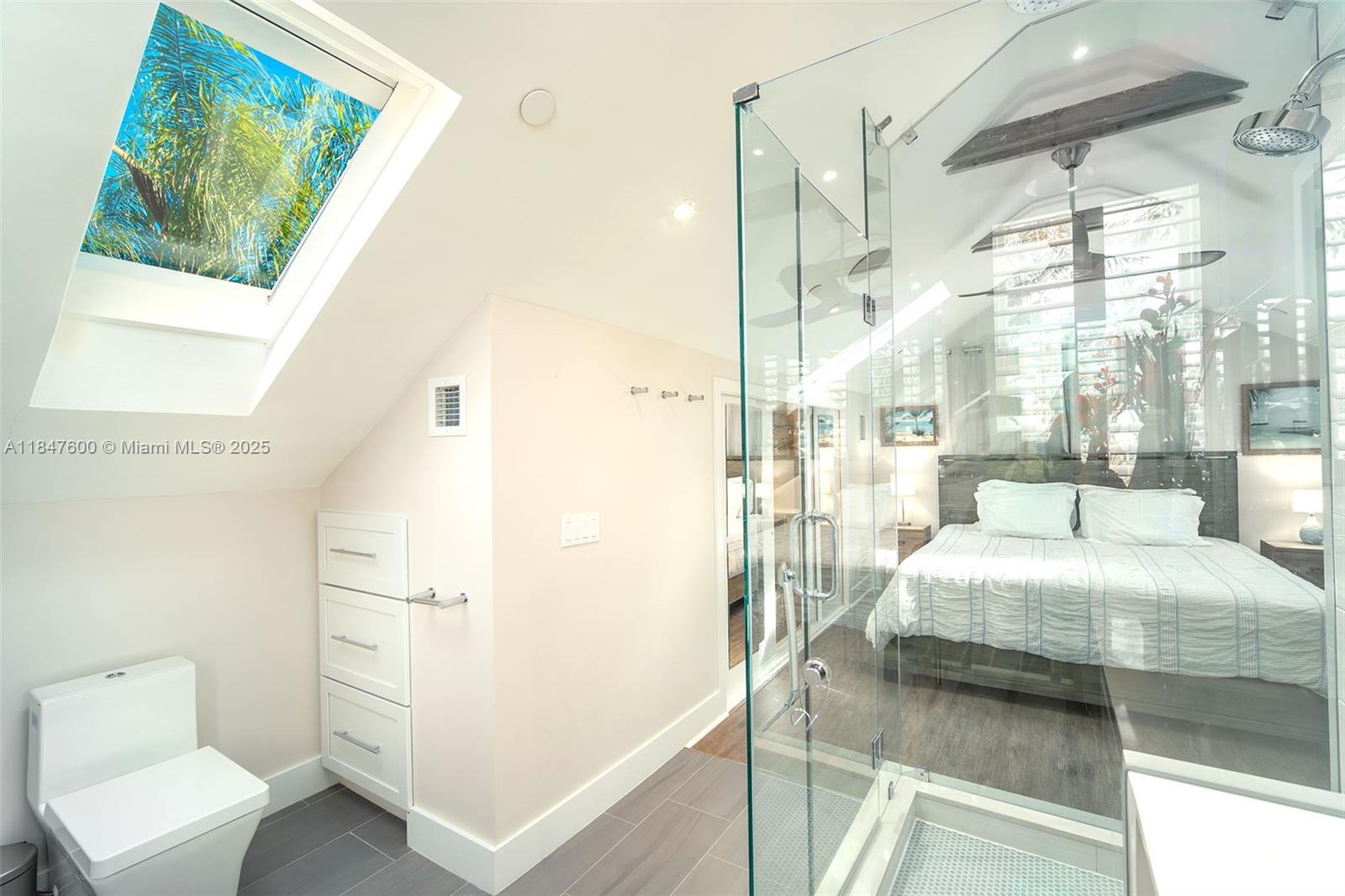 1114 Packer Street Key West, FL 33040 - Photo 97 of 98 a bedroom with a bed and a painting on the wall