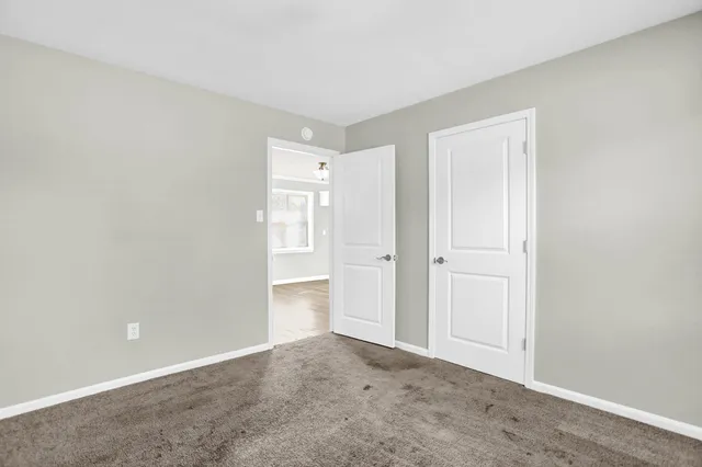 a view of an empty room and closet area