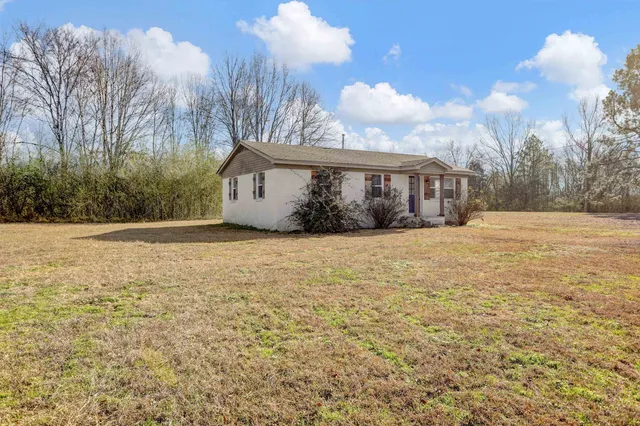 a view of house with snow on the road