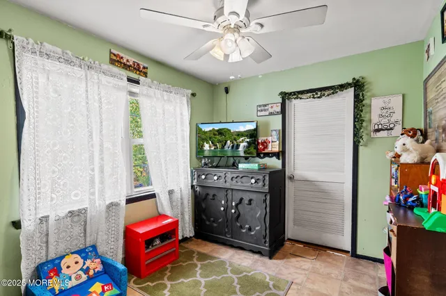 a living room with furniture a dining table and a window