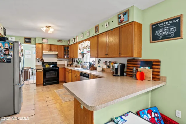 a kitchen with lots of counter top space and stainless steel appliances
