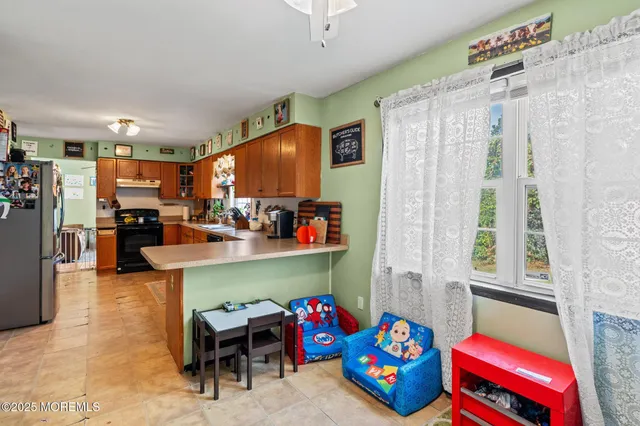 a living room with furniture and a dining table