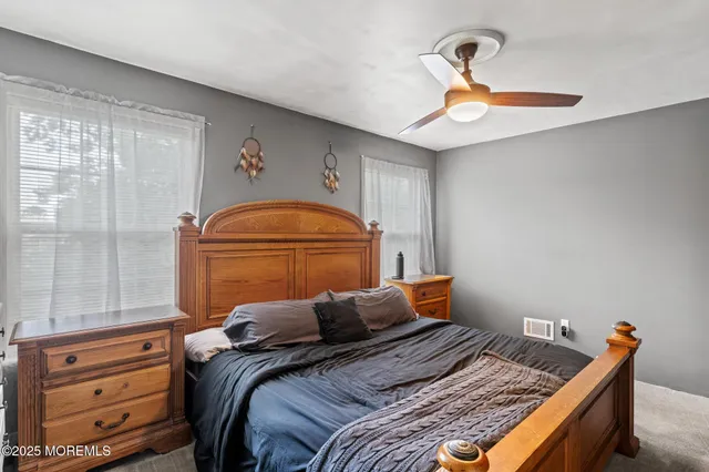 a bed sitting in a bedroom next to a window