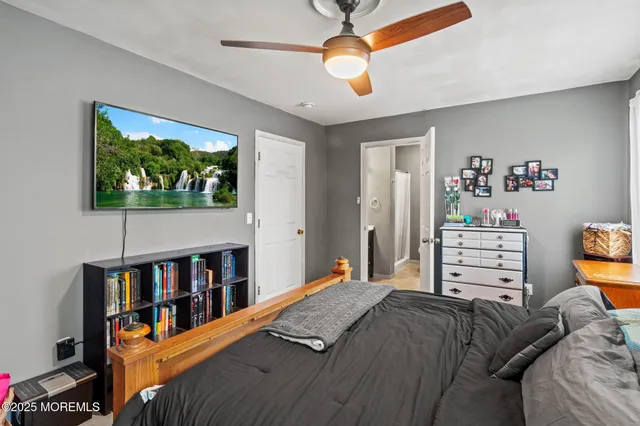 a bedroom with a bed and a book shelf