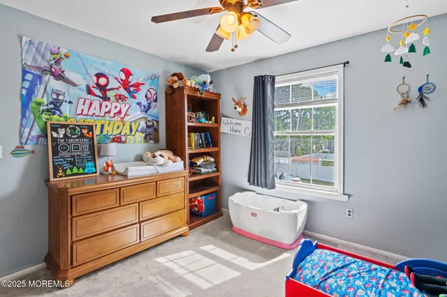 a room with furniture a baby crib and a window