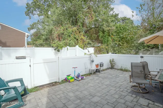 a view of a chairs and table in backyard