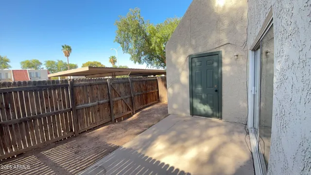 a view of a balcony with wooden floor and fence