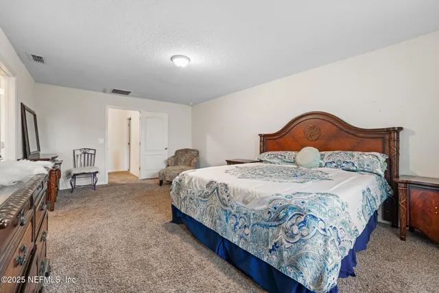 a living room with furniture a flat screen tv and a window