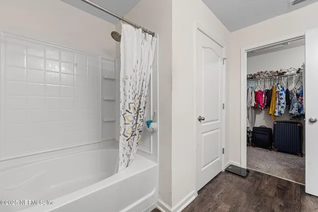 a bedroom with bed and a night stand