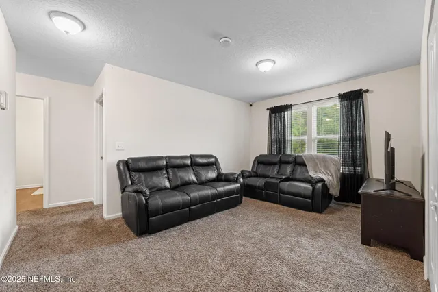 a bedroom with furniture and a gym equipment