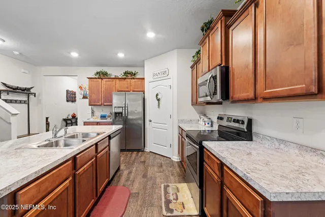 a kitchen with stainless steel appliances granite countertop a sink stove and refrigerator