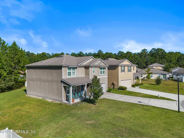 an aerial view of a house with outdoor space pool seating area and yard