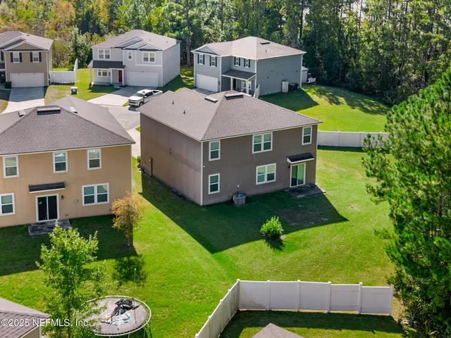 an aerial view of a house with a yard basket ball court and outdoor seating