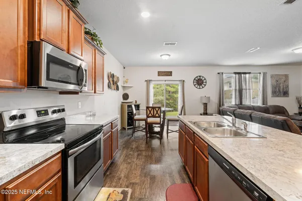 a kitchen with granite countertop stainless steel appliances and wooden cabinets
