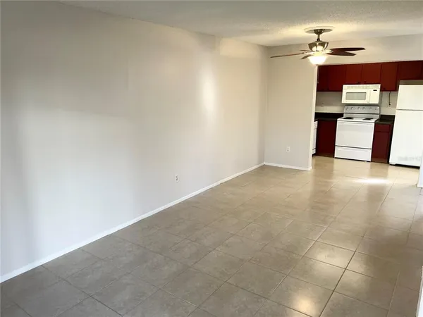 a view of kitchen with granite countertop tops and white appliances