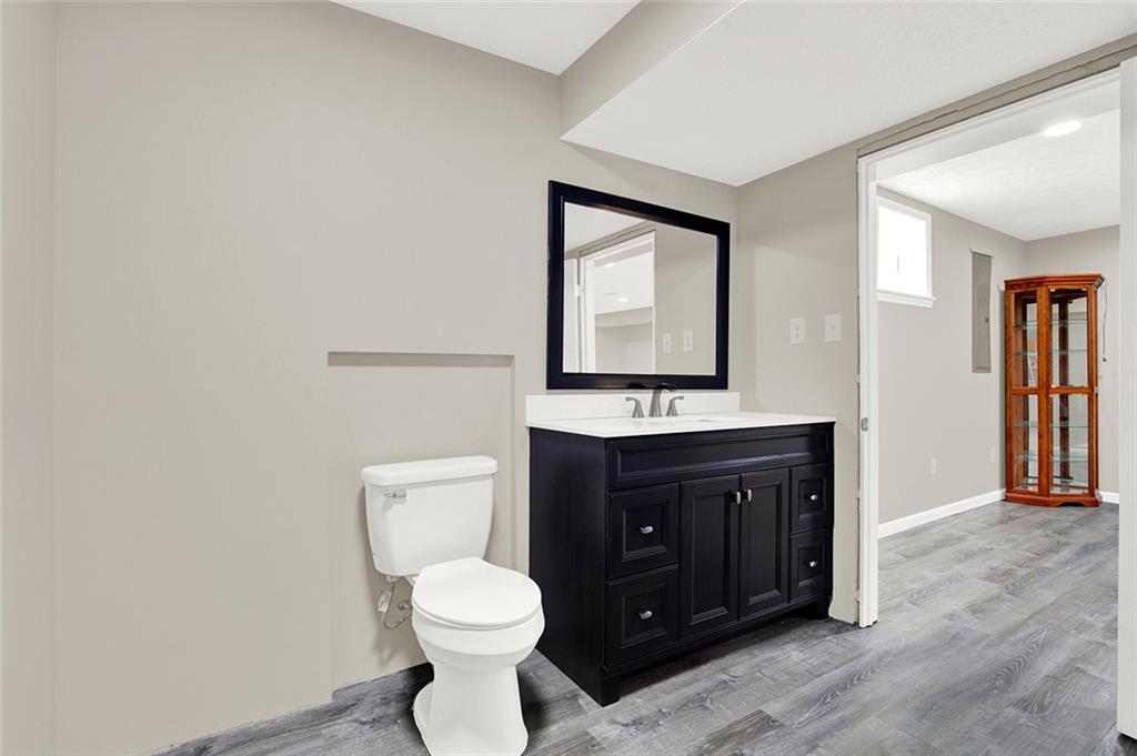 667 Old Frame Road Smithfield, PA 15478 - Photo 33 of 38 a bathroom with a toilet sink vanity and mirror