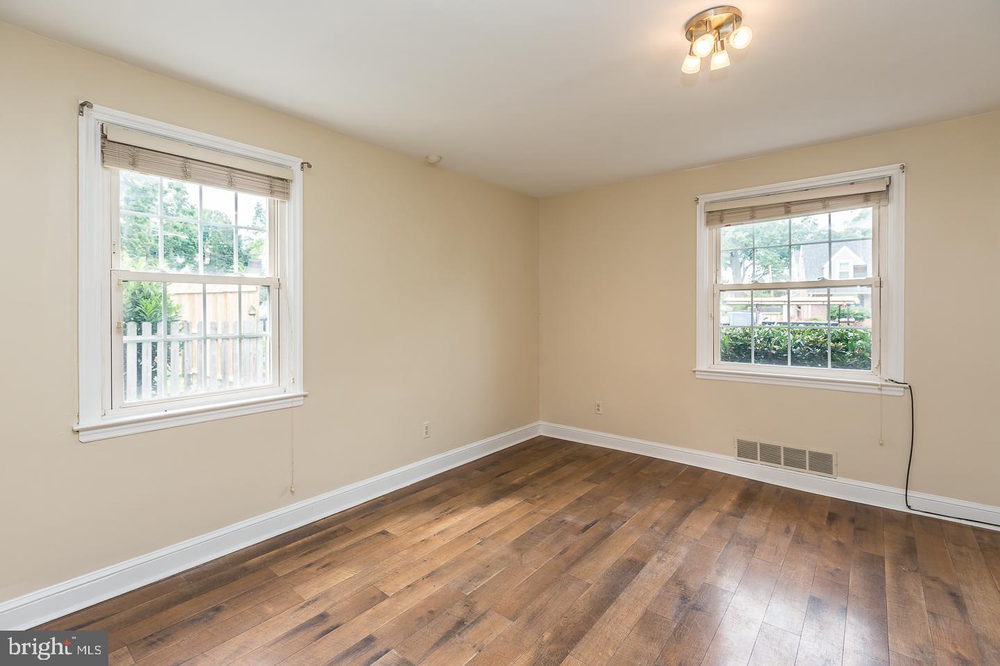 339 East Spring Avenue Ardmore, PA 19003 - Photo 31 of 44 an empty room with wooden floor and windows