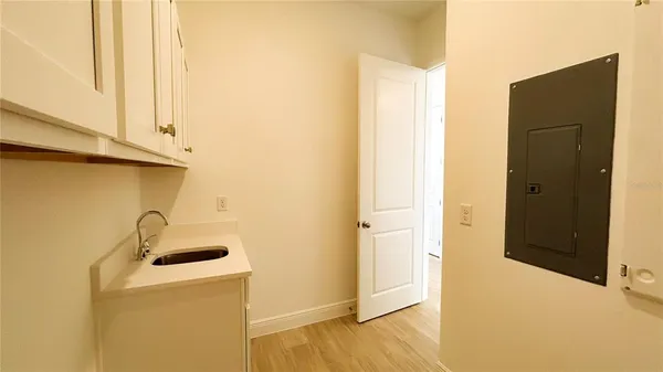 a view of a storage & utility room with a sink