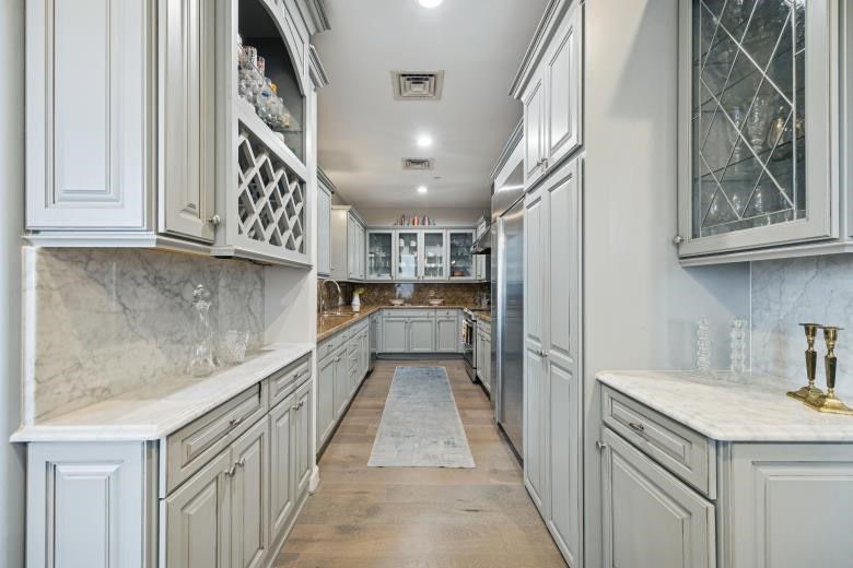 914 Main Street, Unit 1204 Houston, TX 77002 - Photo 7 of 34 Updates galley kitchen with Brookhaven cabinetry and granite/quartz surfaces.