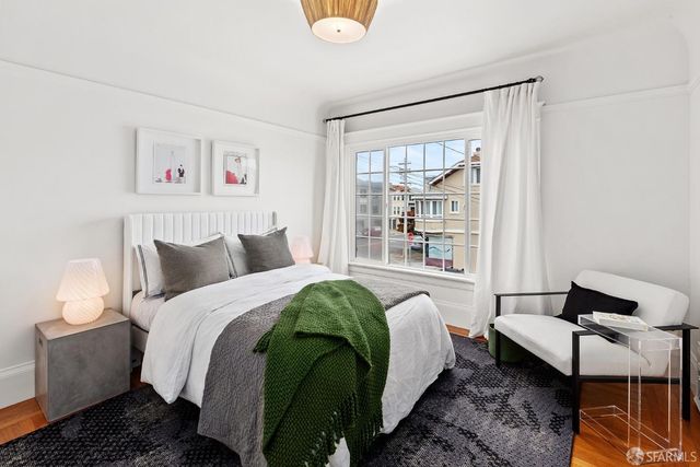 a spacious bedroom with a bed and a window