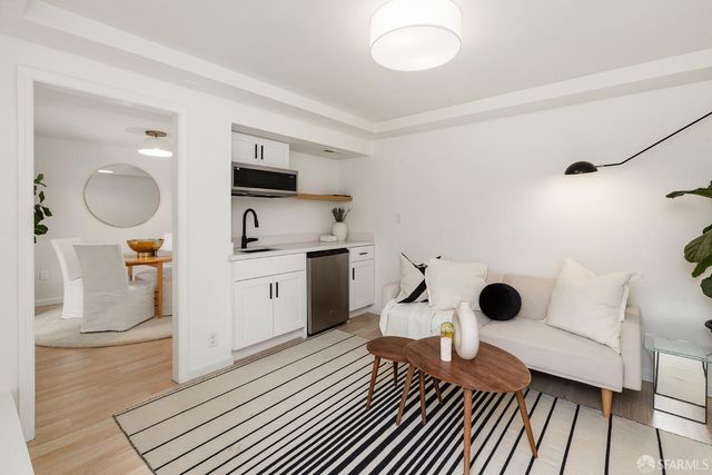 a kitchen with a sink and a stove top oven