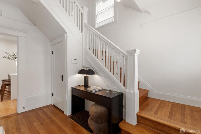 a view of entryway bedroom and gallery with wooden floor