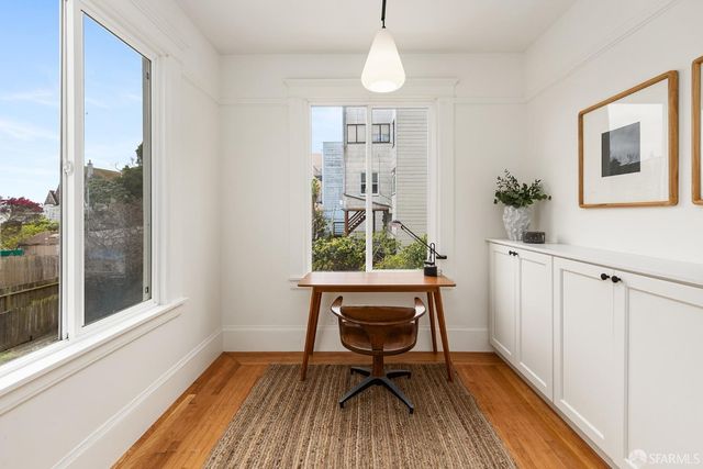 a workspace room with furniture and wooden floor