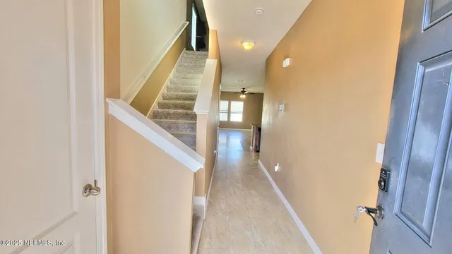 a view of entryway and hall with wooden floor