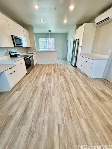 a view of a kitchen with wooden floor and a sink