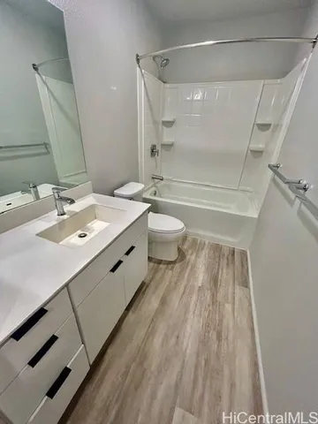 a bathroom with a double vanity sink toilet and shower