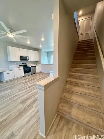 a view of kitchen with sink microwave and cabinets