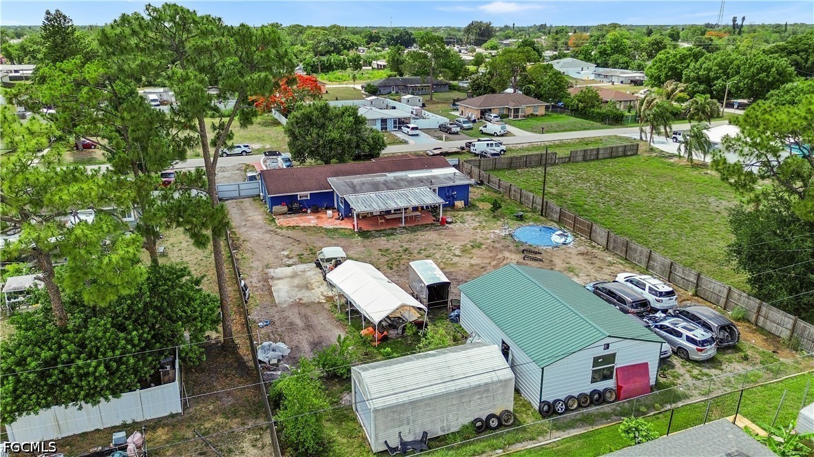 18 Illinois Road Lehigh Acres, FL 33936 - Photo 3 of 45 an aerial view of a house with a yard